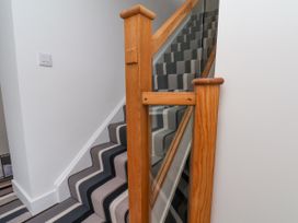 A staircase with a wooden railing at Og's House in Whitby