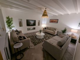 A living room with a sofa and television at Og's House in Whitby