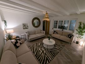 A living room with two sofas, a coffee table, and a lamp at Og's House in Whitby