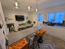 A kitchen with a dining table and television at Og's House in Whitby