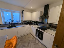 A kitchen with appliances and countertops at Og's House in Whitby