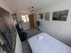 A bedroom with a bed and wall art at Og's House in Whitby