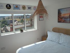 A bedroom with a bed and window at Og's House in Whitby