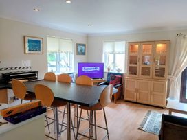 A kitchen with island seating and a television at 29 Pendra Loweth Falmouth