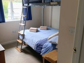 A bedroom with a bunk bed and towels at 29 Pendra Loweth in Falmouth
