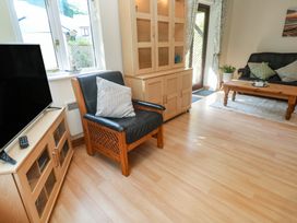 A living room with a television and sofa at Stargazy in Falmouth
