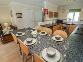 A dining area with a table set for meals at Stargazy in Falmouth