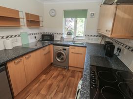 A kitchen with a microwave and cooking appliances at Stargazy in Falmouth