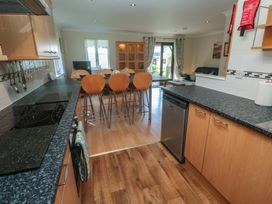 A kitchen with stools and a dining table at Stargazy in Falmouth
