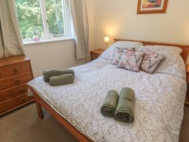 A bedroom with a bed, pillows, and towels at Stargazy in Falmouth