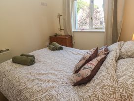 A bedroom with a bed and towels at Stargazy in Falmouth