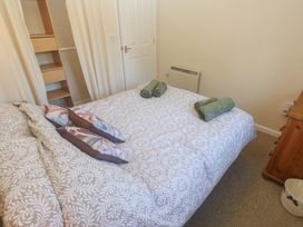 A bedroom with a bed and pillows at Stargazy in Falmouth