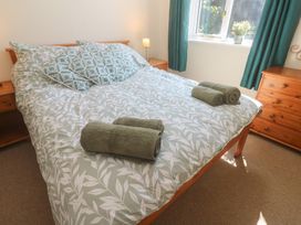 A bedroom with a bed and pillows at Stargazy in Falmouth