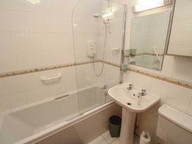 A bathroom with a bathtub, shower, sink, and toilet at Stargazy in Falmouth