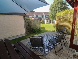A patio area with chairs and a table at Stargazy in Falmouth