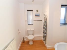 A bathroom with a toilet and towel rail at 1 Marina View in Pwllheli