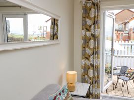 A living room with a sliding door and patio furniture at Harbour View Poole