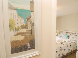 A bedroom with a bed and wall artwork at Harbour View Poole