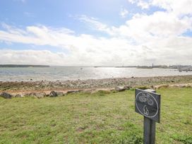 A coastal view with a sign indicating bike and dog area at Harbour View Poole