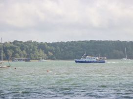 A boat on water with trees in the background at Harbour View Poole