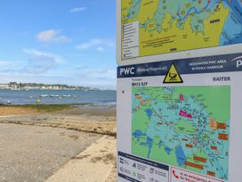 A map and sign near the water showing a personal watercraft area at Harbour View Poole