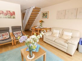 A living room with sofas and a dining table at Poole Quay Cottage in Poole