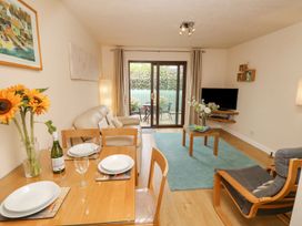 A living room with a sofa and dining area at Poole Quay Cottage in Poole