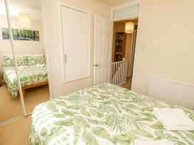 A bedroom with a bed and wardrobe at Poole Quay Cottage in Poole