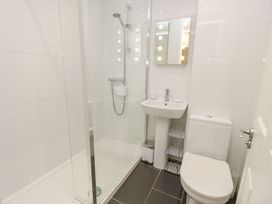 A bathroom with shower, toilet, and sink at Poole Quay Cottage in Poole