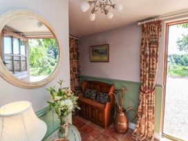 An entryway with a couch and decorative items at Captains Barn in Tiverton