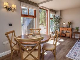 A dining room with a table and chairs at Captains Barn in Tiverton