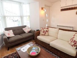 A living room with a sofa and coffee table at Bodefi in Pwllheli