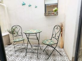 An outdoor space with a table and chairs at Bodefi Pwllheli