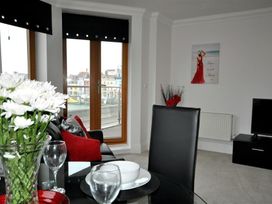 A living room with flowers on a table at Old Harbour View in Weymouth