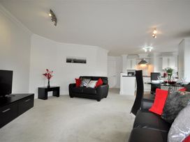 A living room with a sofa and TV at Old Harbour View in Weymouth