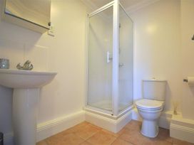A bathroom with a shower, toilet, and sink at Old Harbour View in Weymouth