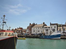 A harbor with boats and buildings at Old Harbour View in Weymouth