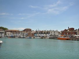 A harbor with boats and buildings at Old Harbour View in Weymouth