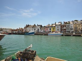 A harbor with boats and buildings at Old Harbour View in Weymouth