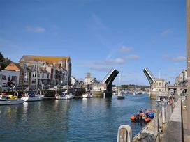 A harbor view with boats and a raised bridge at Old Harbour View in Weymouth
