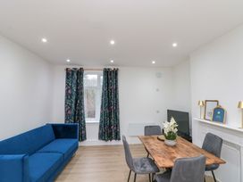 A living room with sofa and dining table at Beachwalk Villa 2 in Whitby