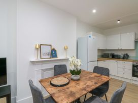 A kitchen with a table and chairs at Beachwalk Villa 2 in Whitby
