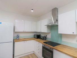 A kitchen with appliances and cabinets at Beachwalk Villa 2 in Whitby