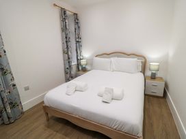 A bedroom with a bed and bedside tables at Beachwalk Villa 2 in Whitby