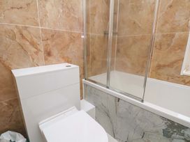 A bathroom with a toilet and shower at Beachwalk Villa 3 in Whitby