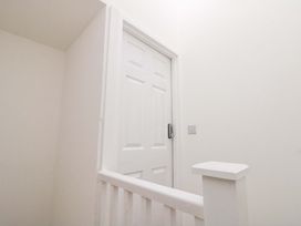 A staircase with a door at Beachwalk Villa 3 in Whitby