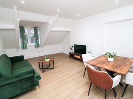 A living room with a sofa and a dining area at Beachwalk Villa 3 in Whitby