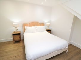 A bedroom with a bed and nightstands at Beachwalk Villa 3 in Whitby