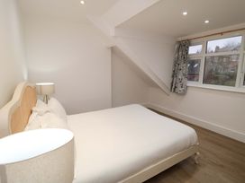 A bedroom with a bed and lamp at Beachwalk Villa 3 in Whitby