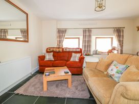 A living room with sofas and a coffee table at Camellia Cottage in Bodmin